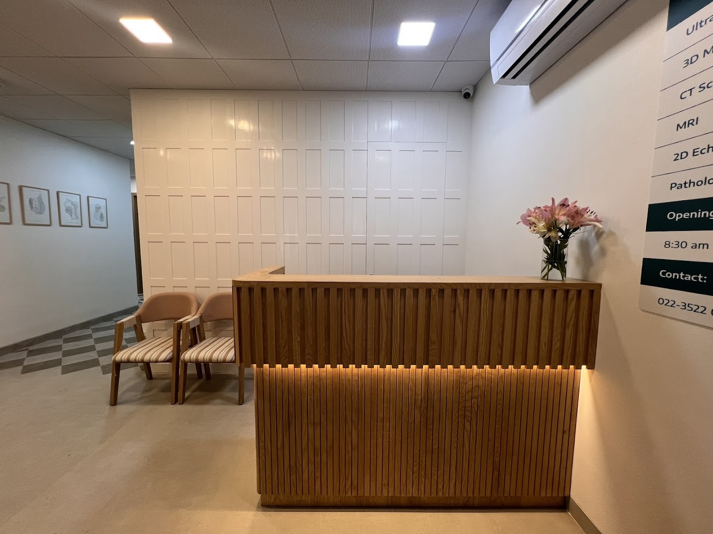 AV Scan Diagnostics warm reception with wooden desk and pink lilies